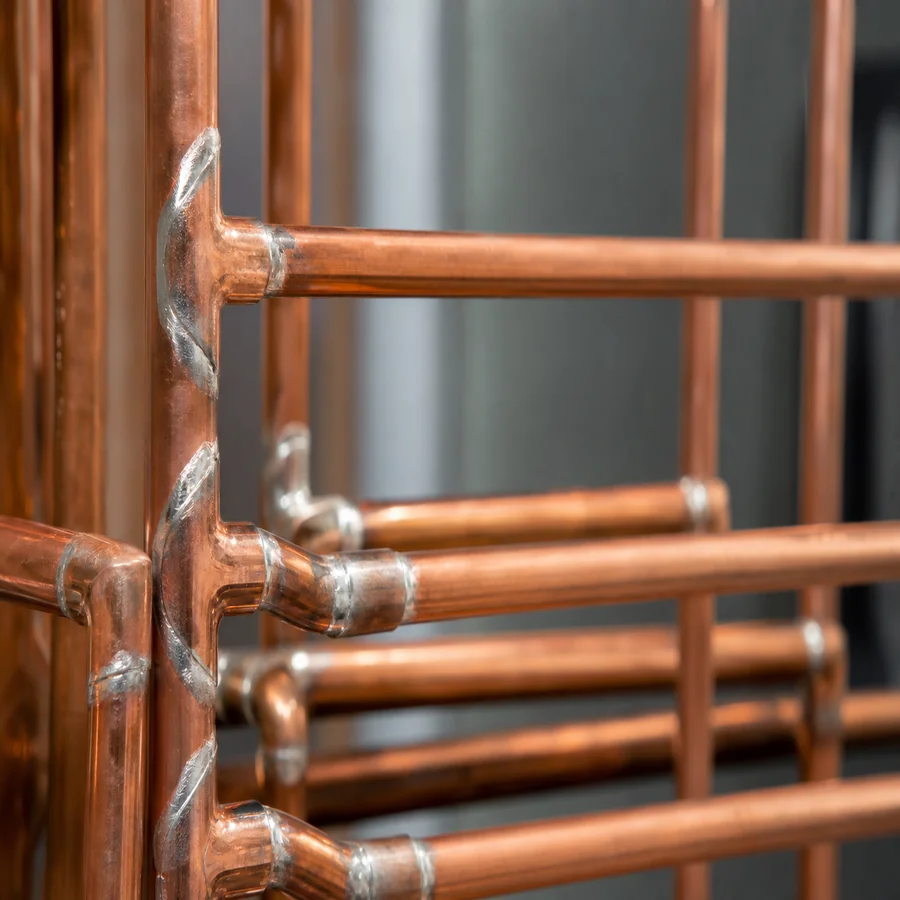 Multiple silver solder joints on copper pipe display rack